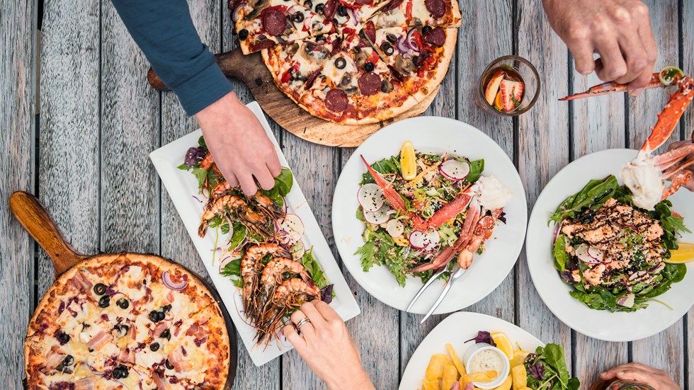 A selection of stone-baked pizza, local seafood and other dishes at Punga Cove in the Marlborough Sounds, New Zealand.